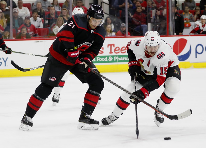 Carolina Hurricanes&#039; Nino Niederreiter (21) battles for the puck with Ottawa Senators&#039; Zack Smith (15) during the first period of an NHL hockey game Friday, Jan. 18, 2019, in Raleigh, N.C. ( ...