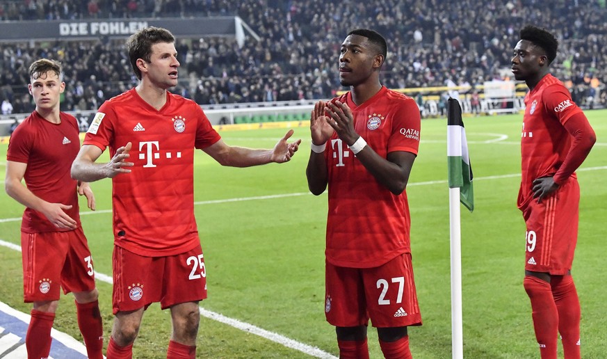 Bayern&#039;s Joshua Kimmich, Thomas Mueller, David Alaba and Alphonso Davies, from left, stand on the pitch disappointed after losing the German Bundesliga soccer match between Borussia Moenchengladb ...