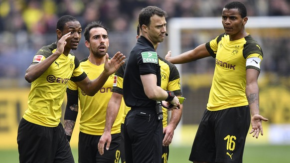 Referee Felix Zwayer reacts to Dortmund&#039;s players after he gave two red cards for Dortmund during the German Bundesliga soccer match between Borussia Dortmund and FC Schalke 04 in Dortmund, Germa ...