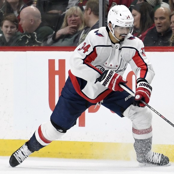 Washington Capitals&#039; Jonas Siegenthaler (34), of Switzerland, takes the puck from Minnesota Wild&#039;s Zach Parise (11) during the second period of an NHL hockey game Sunday, March 1, 2020, in S ...
