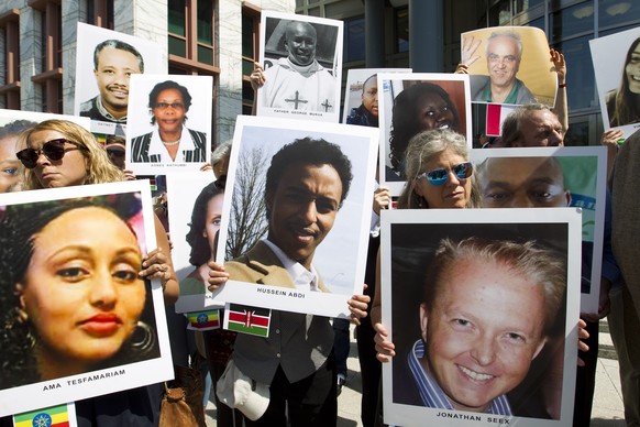 Demonstrators hold pictures of plane crash victims during a vigil on the six-month anniversary of the crash of a Boeing 737 Max 8, killing 157 people in Ethiopia on March 10, which has resulted in the ...