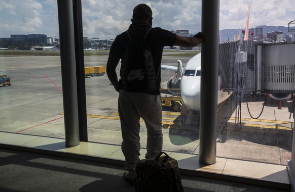 A passenger waits to board a humanitarian flight to Canada at the La Aurora international airport in Guatemala City, Thursday, Sept. 17, 2020. Authorities are preparing for the reopening of the airpor ...