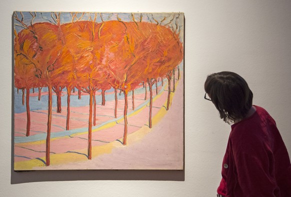 A woman looks at the painting &#039;Autumnal trees&#039; (1911) by Cuno Amiet during the press preview of the exhibition &#039;There is only one program: Freedom!&#039; in the art collection of the to ...