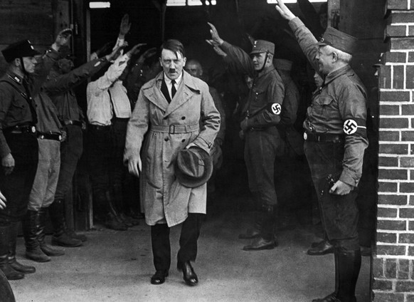 FILE - In this Dec. 5, 1931 file photo, Adolf Hitler, leader of the National Socialists, is saluted as he leaves the party&#039;s Munich headquarters. The book, &quot;Human Rights After Hitler&quot; b ...