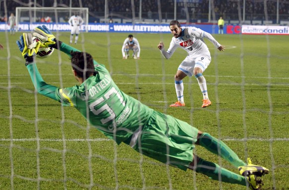 FILE - File photo dated Wednesday, Oct. 29, 2014, Atalanta goalkeeper Marco Sportiello saves a penalty kicked by Napoli&#039;s Gonzalo Higuain during a Serie A soccer match in Bergamo, Italy. (AP Phot ...