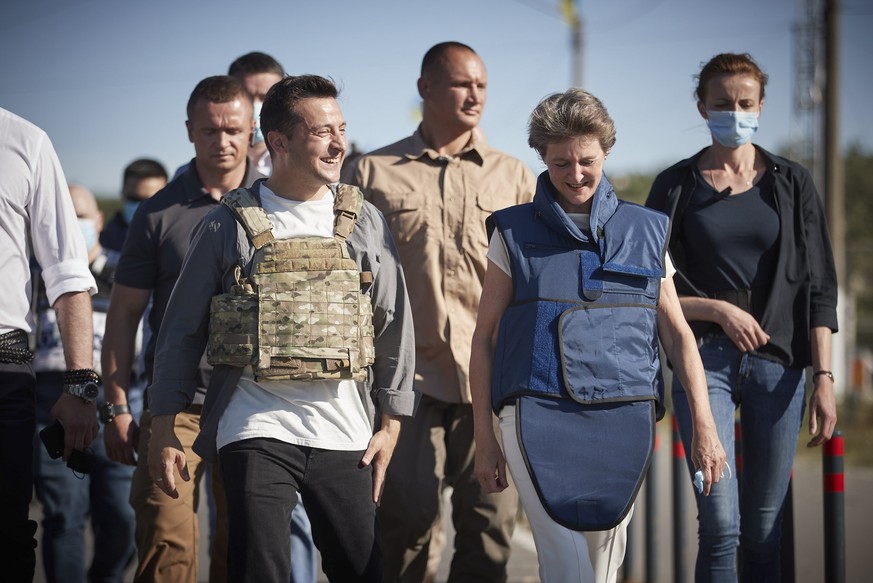 epa08562997 A handout photo made available by Presidential Press Office shows Swiss President Simonetta Sommaruga (R) and Ukrainian President Volodymyr Zelensky (L) wearing bullet-proof vests walk dur ...