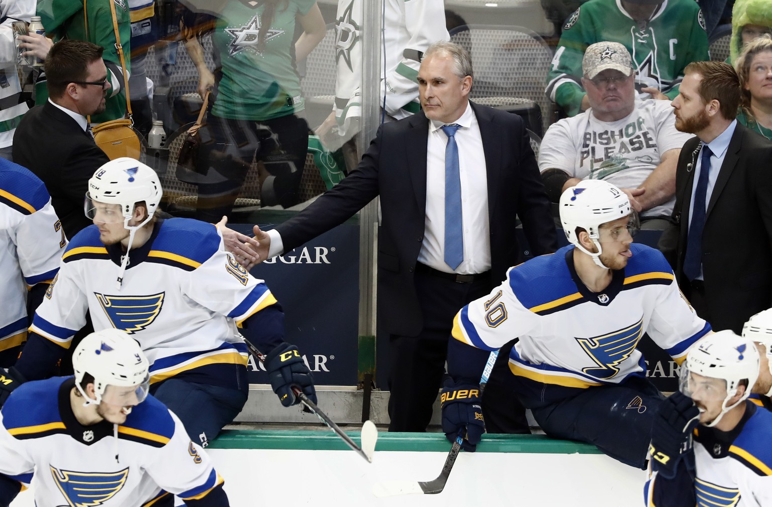 St. Louis Blues interim head coach Craig Berube, center, shakes hands with staff, celebrating the team&#039;s 4-1 win against the Dallas Stars in Game 6 of an NHL second-round hockey playoff series in ...