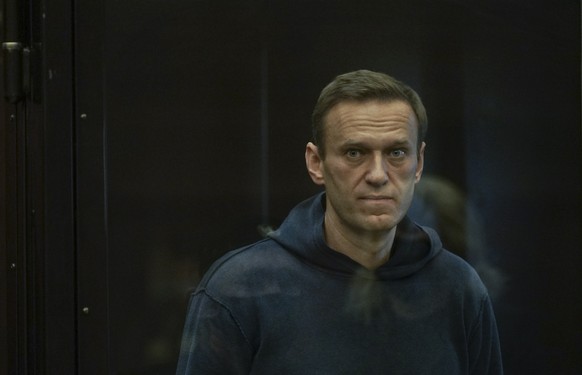 epa08980966 A handout photo made available by Moscow&#039;s Citiy Court Press Service shows Russian opposition leader Alexei Navalny (L) standing in the glass cage during a hearing in the Moscow City  ...