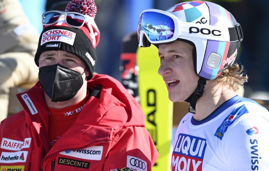 epa09011617 Beat Feuz (L) and Marco Odermatt (R) of Switzerland react in the finish area during the Men&#039;s Downhill race at the FIS Alpine Skiing World Championships in Cortina d&#039;Ampezzo, Ita ...