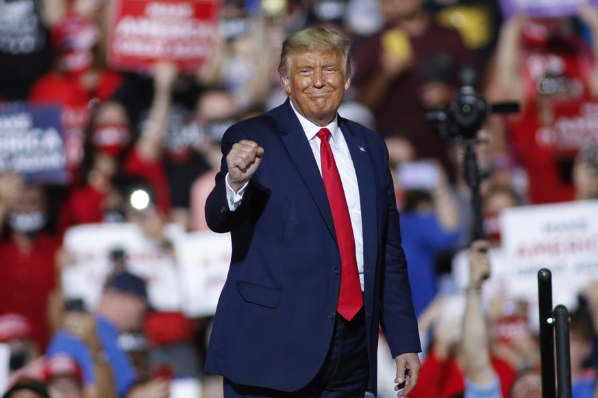 President Donald Trump pumps his fist after speaking at a campaign rally in Gastonia, N.C., Wednesday, Oct. 21, 2020. (AP Photo/Nell Redmond)