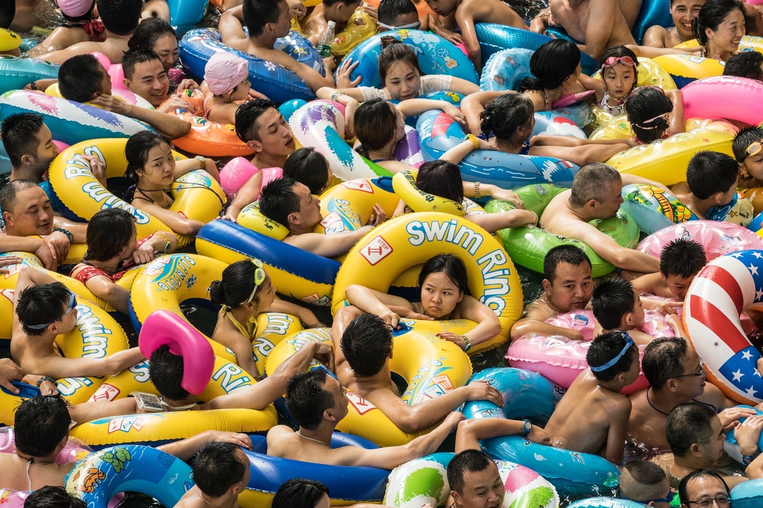 epa06105231 Chinese tourists with swim rings enjoy swimming in the lake called &#039;Dead sea of China&#039; in a resort of Suining city, southwestern China&#039;s Sichuan province, 22 July 2017. More ...
