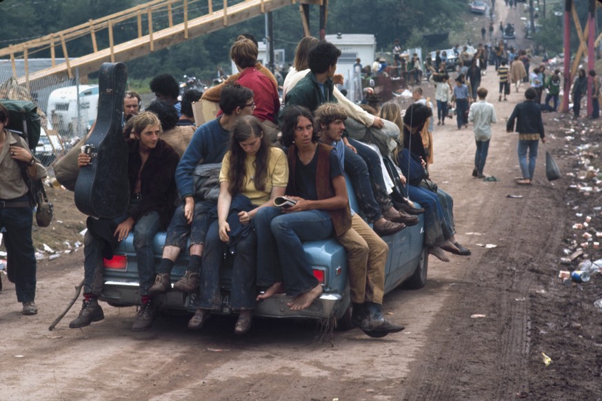Hippies catching a ride on a car at Woodstock, Bethel, New York State, August 1969. (Photo by Bill Eppridge/The LIFE Picture Collection via Getty Images)