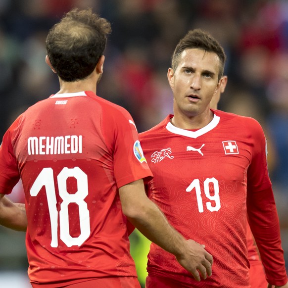 Switzerland&#039;s forward Admir Mehmedi, left, and Switzerland&#039;s forward Mario Gavranovic, right, reacts after the fourth goal during the UEFA Euro 2020 qualifying Group D soccer match between t ...