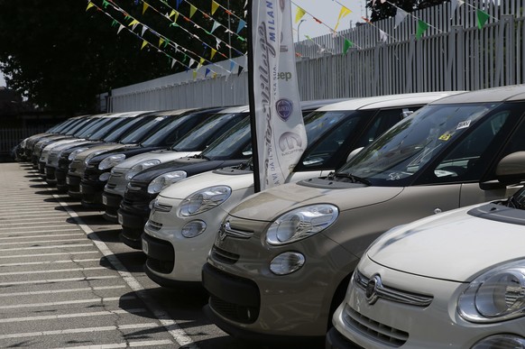 FILE - In this Wednesday, July 25, 2018 file photo, cars are parked at a Fiat Chrysler car dealer in Milan, Italy. European car sales bottomed out last month as the automotive industry faces the worst ...