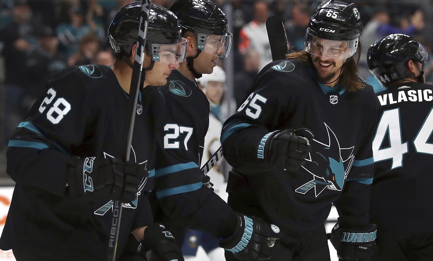 San Jose Sharks&#039; Joonas Donskoi (27) celebrates with Timo Meier, left, and Erik Karlsson (65) after scoring a goal against the Buffalo Sabres during the first period of an NHL hockey game Thursda ...