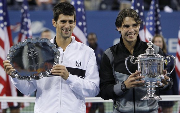 Rafael Nadal, right, of Spain, and Novak Djokovic of Serbia, pose with their trophies after Nadal beat Djokovic to win the men&#039;s championship match at the U.S. Open tennis tournament in New York, ...
