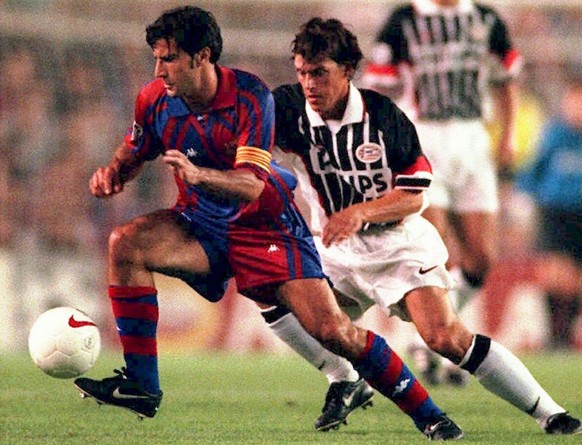 Barcelona&#039;s Portuguese player Luis Figo, left, controls the ball in front of Dutch side PSV Eindhovens&#039; Polish midfielder Tomek Iwan during a Champions&#039; League soccer match in Barcelona ...