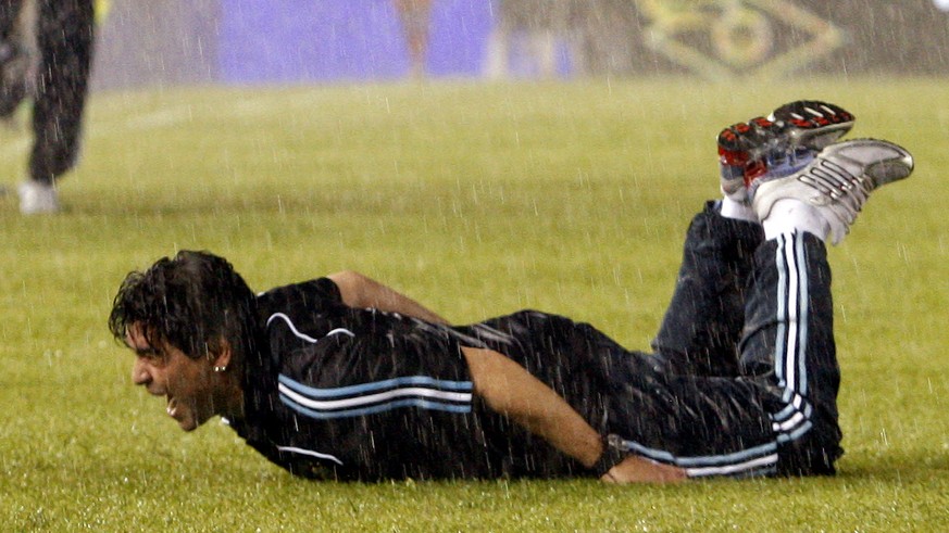 Under pouring rain, Argentina&#039;s coach Diego Maradona celebrates at the end of a 2010 World Cup qualifying soccer match against Peru in Buenos Aires, Saturday, Oct. 10, 2009. Argentina won 2-1. (A ...