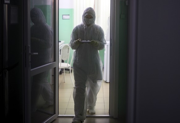 A medical staffer works with test systems for the diagnosis of coronavirus at the Krasnodar Center for Hygiene and Epidemiology microbiology lab in Krasnodar, Russia, Tuesday, Feb. 4, 2020. Russia has ...