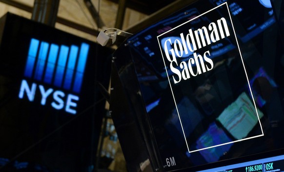 epa08945704 (FILE) - A sign of US bank Goldman Sachs on the floor of the New York Stock Exchange at the start of the trading day in New York, New York, USA, 15 July 2014 (reissued 18 January 2021). Th ...
