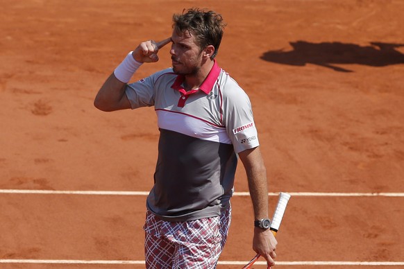 Switzerland&#039;s Stan Wawrinka reacts as he wins the third set against France&#039;s Jo-Wilfried Tsonga during their semifinal match of the French Open tennis tournament at the Roland Garros stadium ...