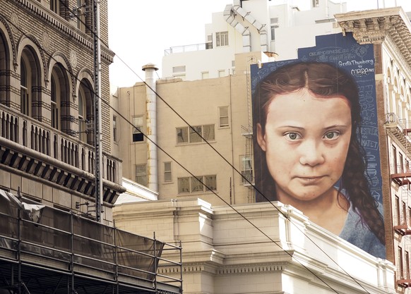 epa07991953 A mural on a side of a building depicts Swedish teenage climate activist Greta Thunberg, near Union Square in downtown San Franicsco, California, USA, 12 November 2019. The mural of Thunbe ...