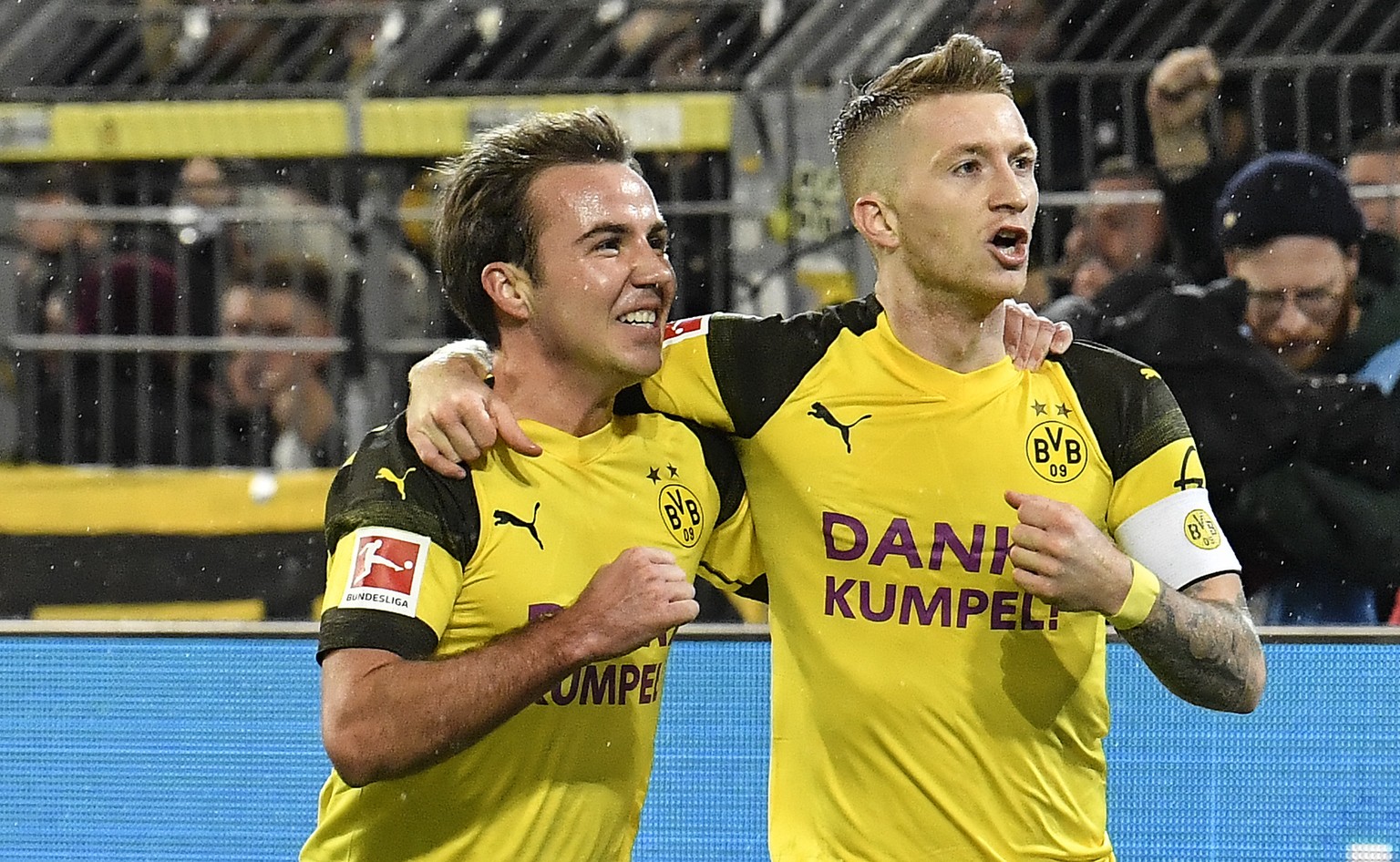 Dortmund&#039;s Marco Reus, right, celebrates after he scored his side&#039;s second goal after an assist by Dortmund&#039;s Mario Goetze, left, during the German Bundesliga soccer match between Borus ...