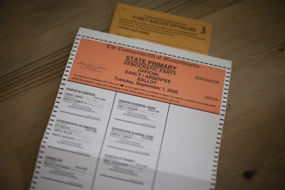 epa08609542 A Massachusetts Democratic Early/Absentee election ballot is seen in Burlington, Massachusetts, USA, 17 August 2020. Policy changes implemented by Postmaster General Louis DeJoy such as re ...