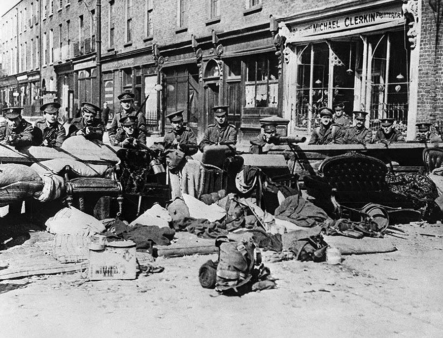 (Original Caption) 5/11/1916 - Dublin, Ireland: Easter Rebellion - Photo shows British troops armed with machine guns and rifles behind a moveable barricade composed of household furniture and which c ...