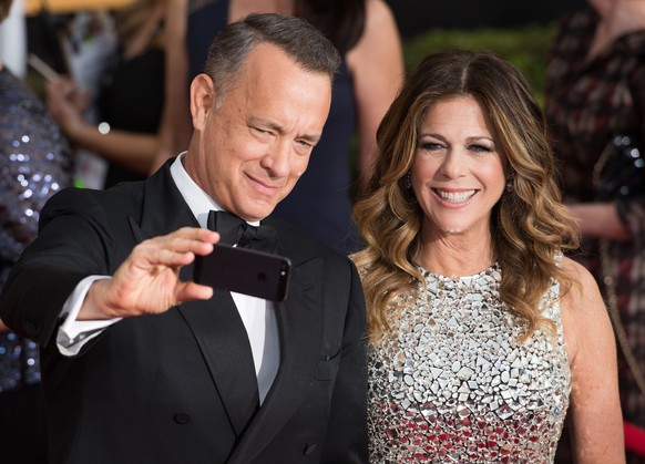 Jan. 18, 2014 - Los Angeles, California, U.S - TOM HANKS takes a selfie of himself and his wife RITA WILSON on the red carpet during arrivals for the 20th Annual Screen Actors Guild Awards at the Shri ...
