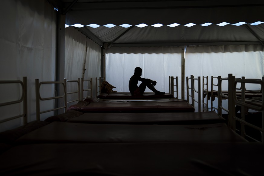 Mamadou Patherazi, from Guinea, sits on a bunk bed of the Modern Christian Mission Church in Fuerteventura, one of the Canary Islands, Spain, on Saturday, Aug. 22, 2020. The Modern Christian Mission i ...