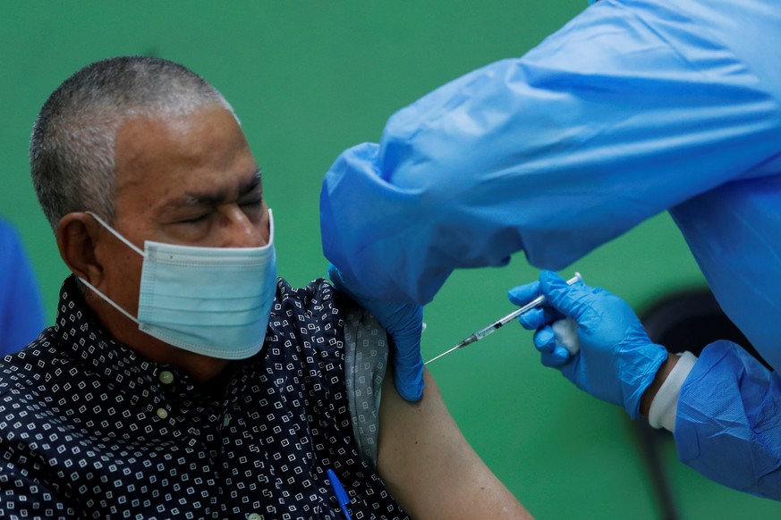 epa09117334 A man receives the second dose of the Pfizer vaccine against covid-19, at the Republica de Colombia school, in San Miguelito, Panama, 05 April 2021. Panama, with 356,377 cases of covid-19  ...