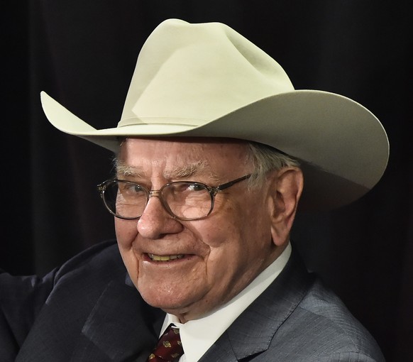epa04879107 (FILE) A file photo dated 08 April 2015 showing Nebraska Furniture Mart and Berkshire Hathaway, CEO Warren Buffett waving to the crowd after playing a ukulele while wearing a cowboy hat af ...