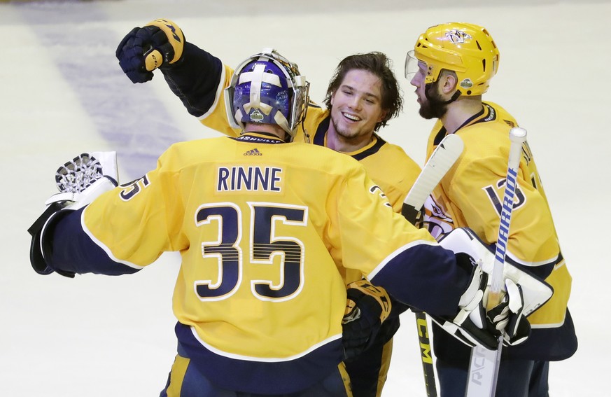 Nashville Predators left wing Kevin Fiala, of Switzerland, center, celebrates with goalie Pekka Rinne (35), of Finland, after Fiala scored the winning goal against the Winnipeg Jets during the second  ...