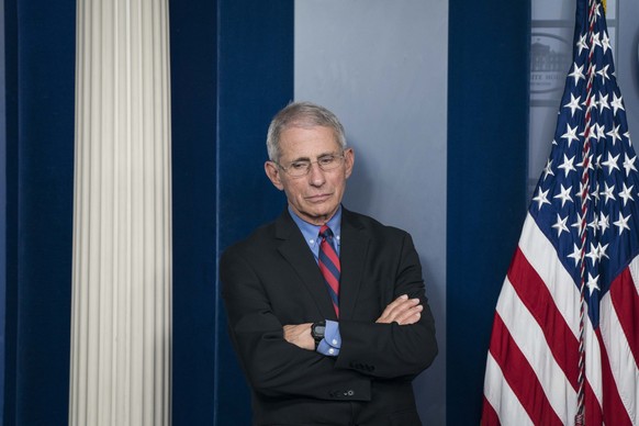 epa08322918 Dr. Anthony Fauci, director of the National Institute of Allergy and Infectious Diseases listens as President Donald Trump delivers remarks on the COVID-19 (Coronavirus) pandemic, during a ...