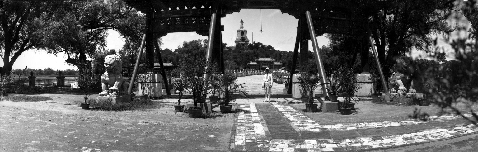 This is a general view of the guilded wooden gateway leading into the Imperial Summer Palace in Peking, China, on June 17, 1935. In the background is a bell-shaped shrine within the grounds of the pal ...
