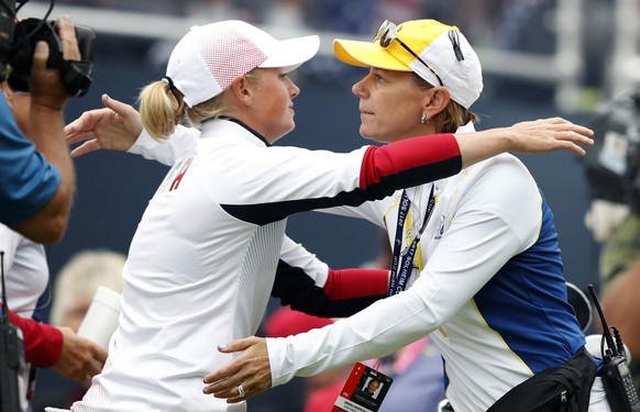 United States&#039; Stacy Lewis, left, gets a hug from Europe captain Annika Sorenstam, of Sweden, before Lewis&#039; foursomes match at the Solheim Cup golf tournament, Friday, Aug. 18, 2017, in West ...