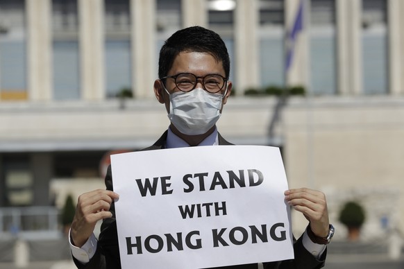 FILE - In this Aug. 25, 2020, file photo, Hong Kong activist Nathan Law takes part in a protest during a meeting of Chinese Foreign Minister Wang Yi with Italian Foreign Minister Luigi Di Maio, in Rom ...