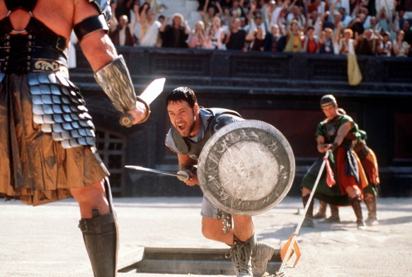 Russell Crowe center fights a gladiator in his role as Roman general Maximus, in this handout photo from Universal&#039;s film &quot;Gladiator,&quot; directed by Ridley Scott. Colleagues say the 36-ye ...