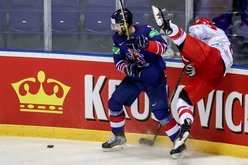 epa07570059 Brett Perlini of Great Britain (L) in action against Phillp Bruggisser of Denmark (R) during the IIHF World Championship group A ice hockey match between Great Britain and Denmark at the S ...