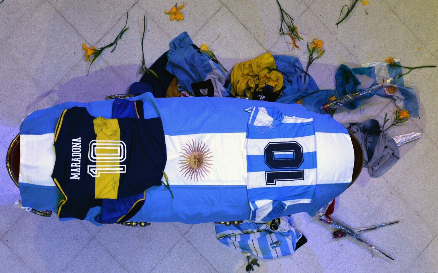 In this photo released by Argentina&#039;s Presidency the coffin with the remains of Diego Maradona lies in state inside the presidential palace in Buenos Aires, Argentina, Thursday, Nov. 26, 2020. Th ...