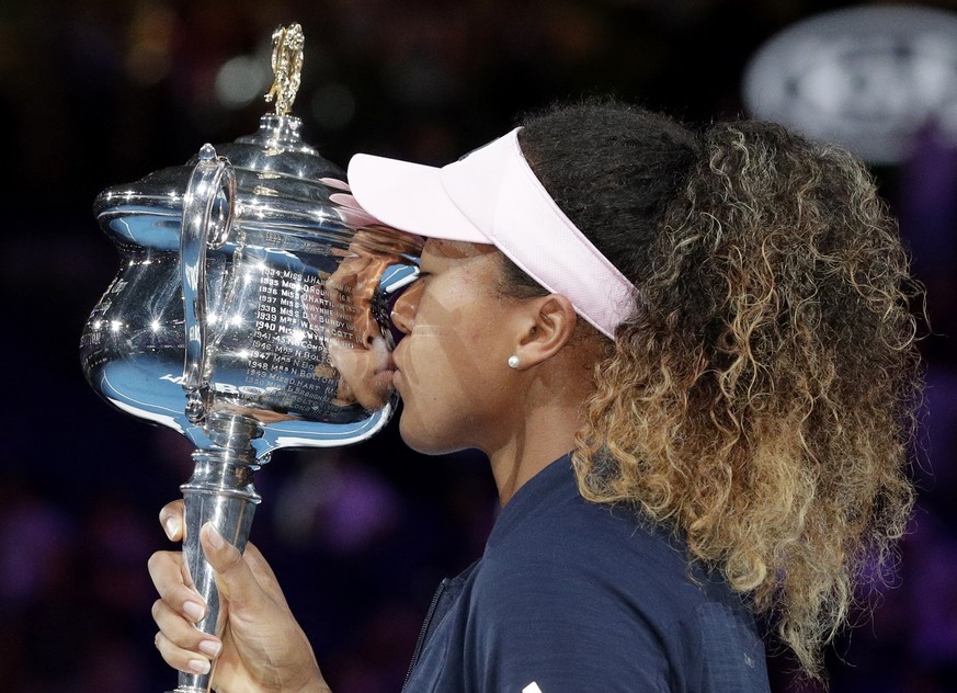 Japan&#039;s Naomi Osaka kisses her trophy after defeating Petra Kvitova of the Czech Republic in the women&#039;s singles final at the Australian Open tennis championships in Melbourne, Australia, Sa ...