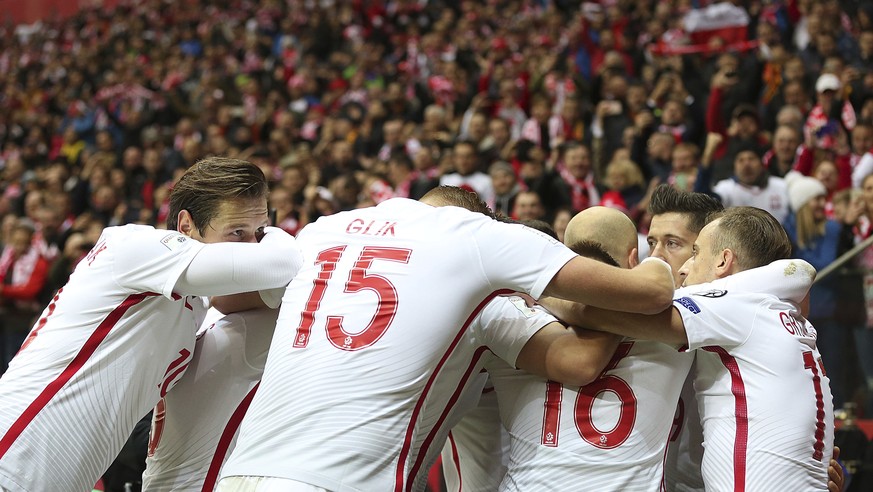 Poland&#039;s Robert Lewandowski celebrates scoring with teammates during the World Cup Group E qualifying soccer match between Poland and Montenegro at National stadium in Warsaw, Poland, Sunday, Oct ...