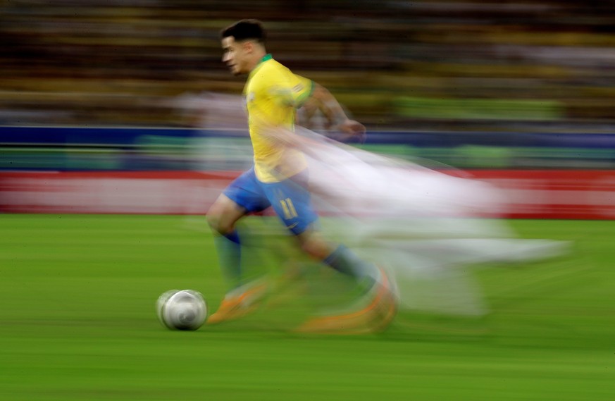 epa07702397 A picture taken with panning technique shows Brazilian Philippe Coutinho in action, during the Copa America 2019 final soccer match between Brazil and Peru, at Maracana Stadium in Rio de J ...