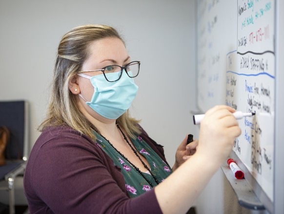 Heather Griggs, a registered nurse and operations chief of the Umatilla County Public Health Department contact tracing center in Pendleton, Ore., updates a list of job assignments on Tuesday, July 14 ...