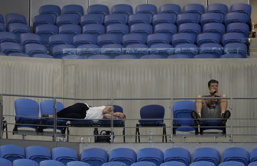 A spectator sleeps at Margaret Court Arena as Spain&#039;s Garbine Muguruza and Britain&#039;s Johanna Konta play their second round match at the Australian Open tennis championships in Melbourne, Aus ...