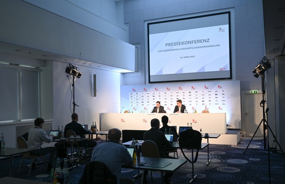 epa08298330 Few journalists attend a press conference hold by Christian Seifert (L), CEO of the DFL and Christian Pfennig (R), responsible for the global image of the Bundesliga and Bundesliga 2, afte ...