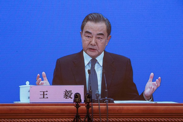 epa08440680 Chinese Foreign Minister Wang Yi is seen on a screen as he speaks to reporters during an online press conference in Beijing, China, 24 May 2020. China held the Chinese People&#039;s Politi ...