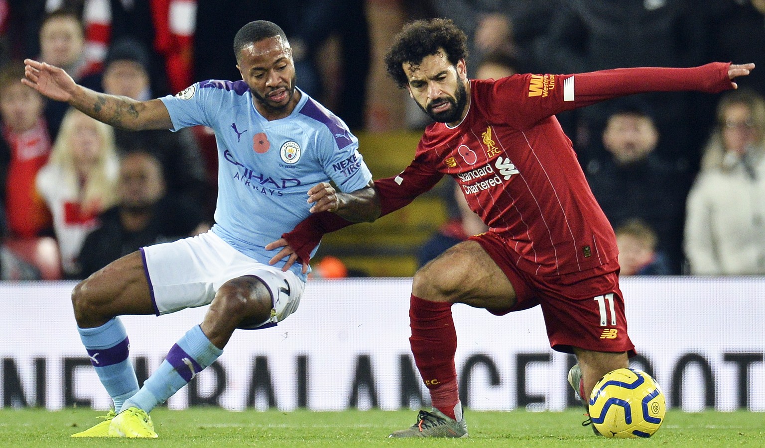 epa07986506 Mohamed Salah (R) of Liverpool in action against Raheem Sterling (L) of Manchester City during the English Premier League soccer match between Liverpool FC and Manchester City in Liverpool ...