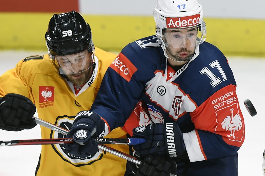 Zurich&#039;s Ryan Shannon, right, fights for the puck against Lugano&#039;s Daniel Sondell, left, during the ice hockey Champions League match 1/8 Final between HC Lugano and ZSC Lions in Zurich, Swi ...
